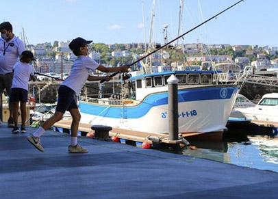 Boy fishing in the port of Donostia